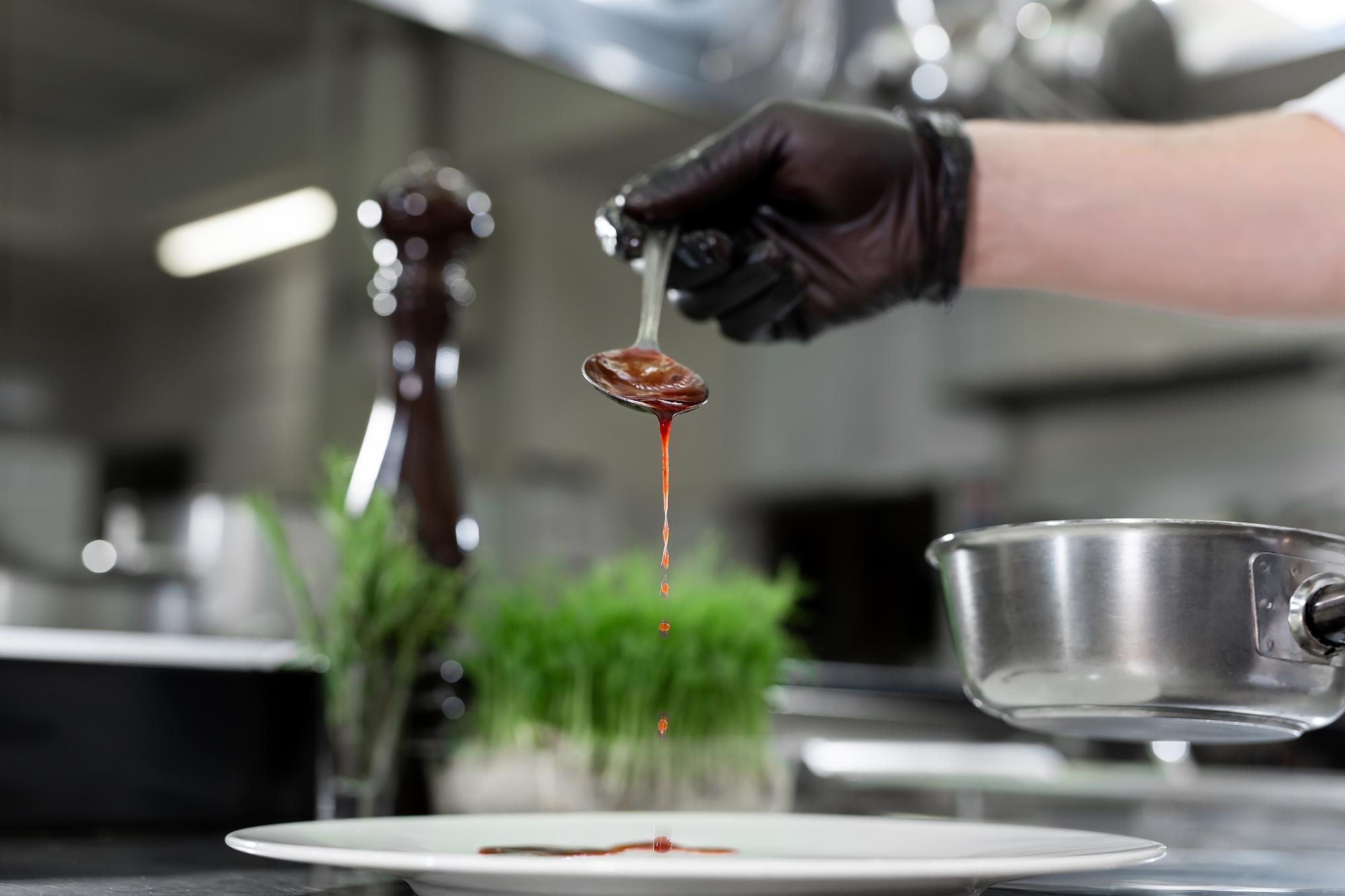 precision pouring sauce with pipette in studio